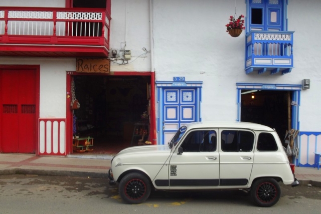 An old classic outside colourful houses in Salento, Colombia