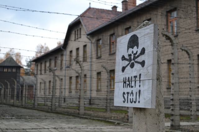 Barbed wire and warning sign in Auschwitz