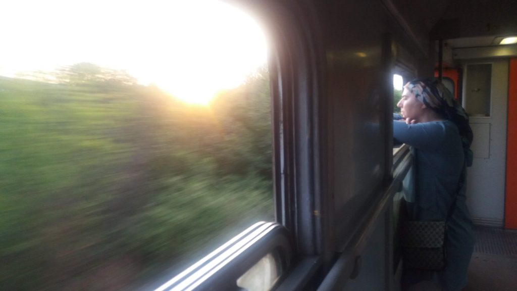 A woman leans out a train window - Belgrade to Sofia